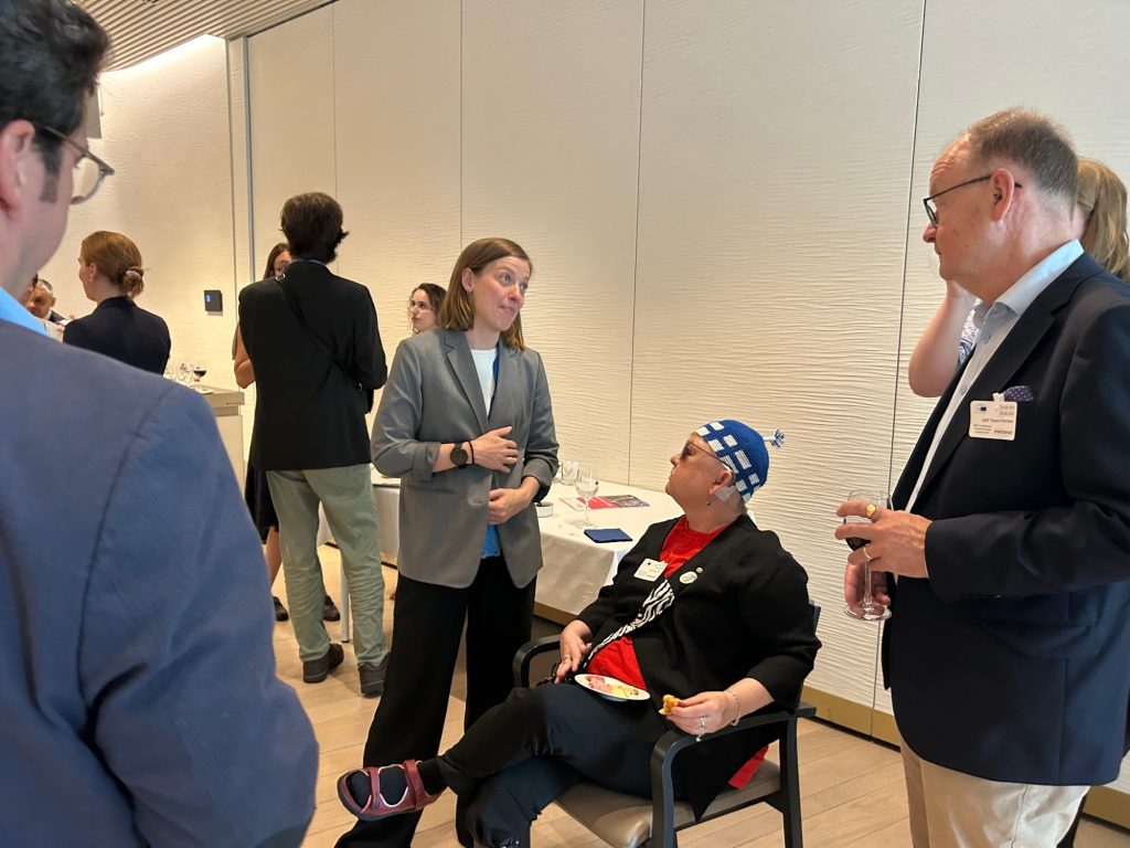 Three people talking to each other at conference.